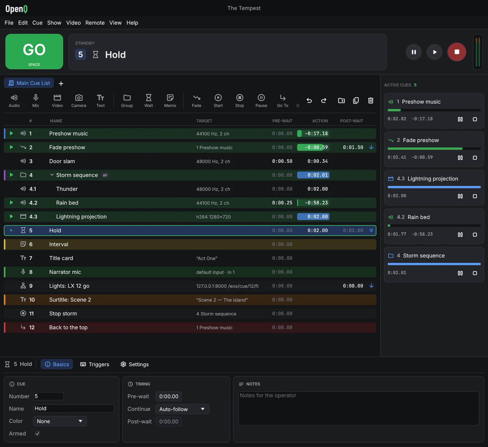 OpenQ running a show: the GO button, the standby cue, a cue list with audio, video, text, group, fade and network cues, and the cues that are playing